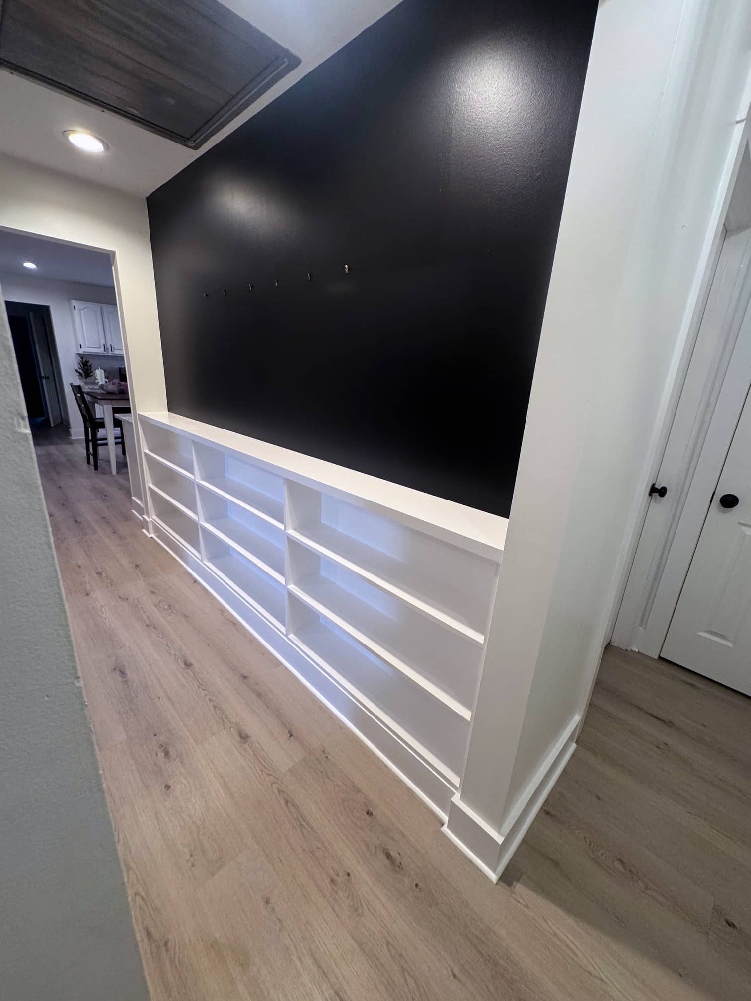 Hallway with hardwood floors and modern recessed lighting in an East Columbus renovation